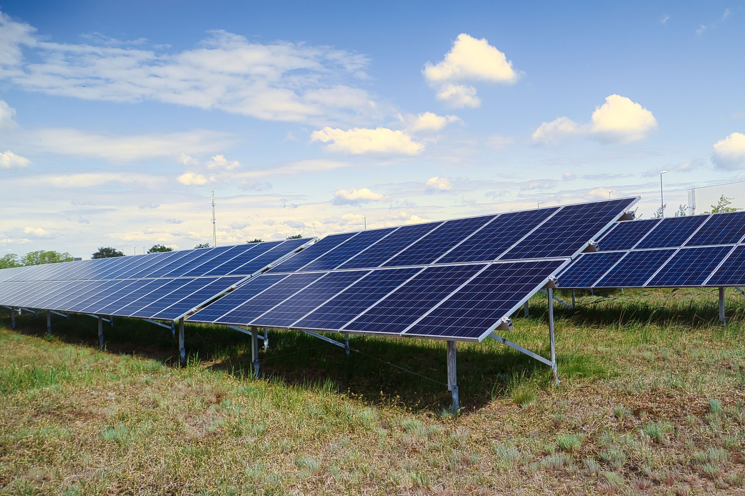 The solar panel in the field under a cloudy sky